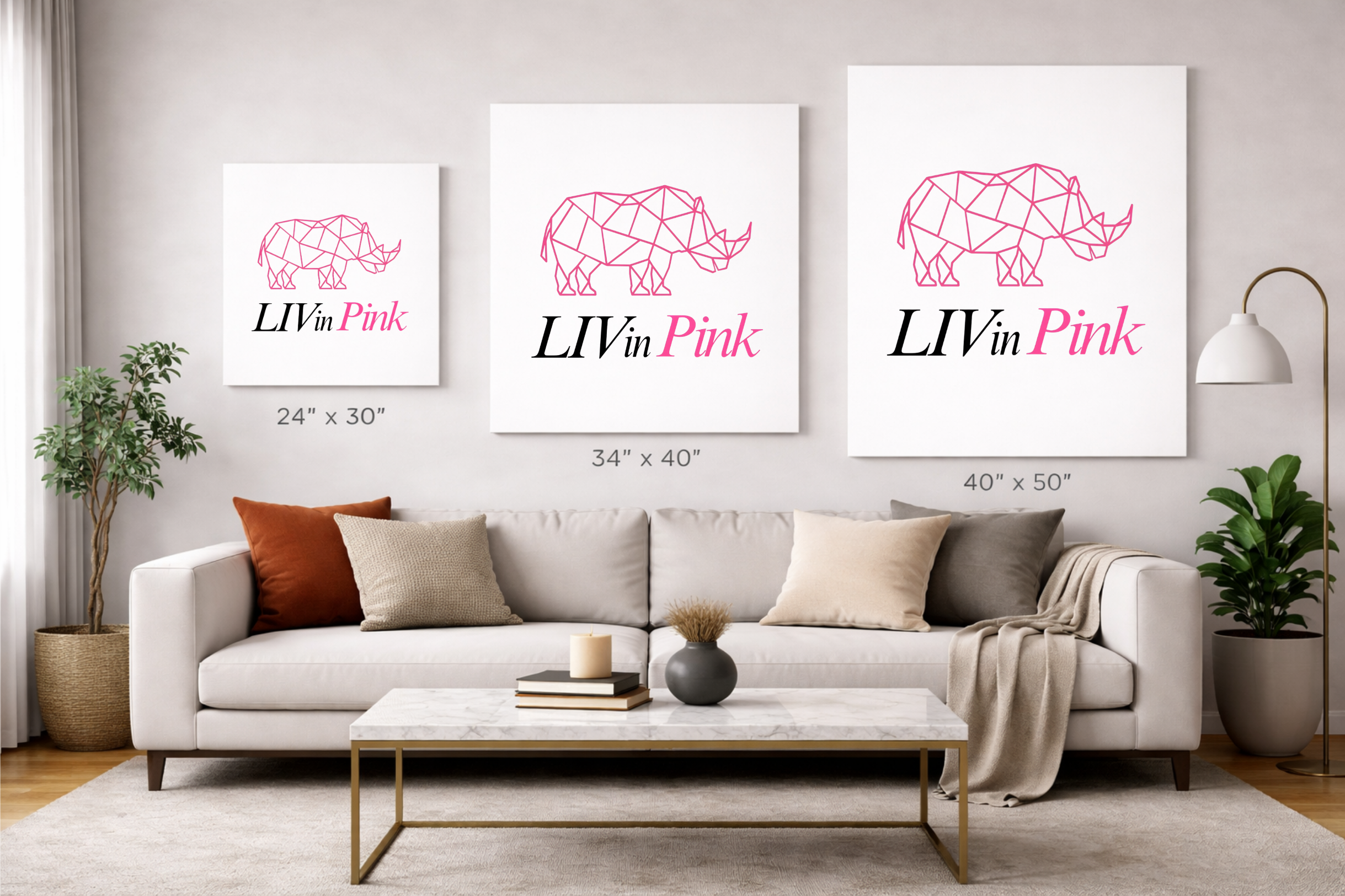 Living room with a sofa, coffee table, and three framed artworks of rhinos with 'LIVin Pink' text.